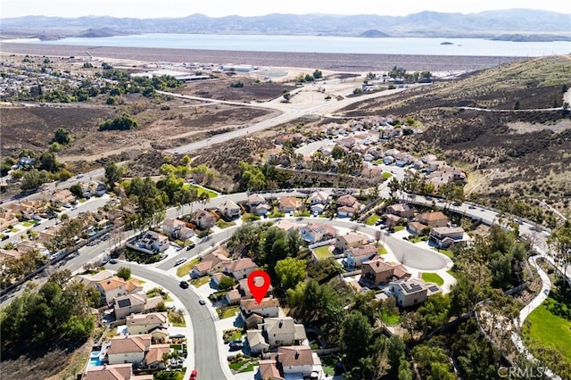 drone / aerial view with a residential view and a water and mountain view