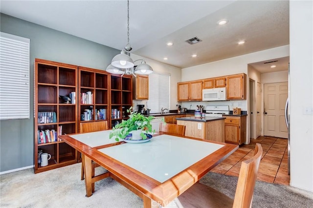 dining room with light tile patterned floors, light carpet, visible vents, and recessed lighting