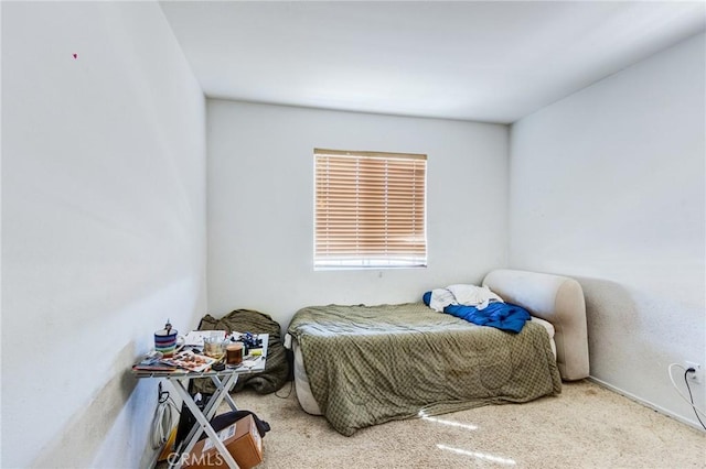 bedroom featuring light colored carpet