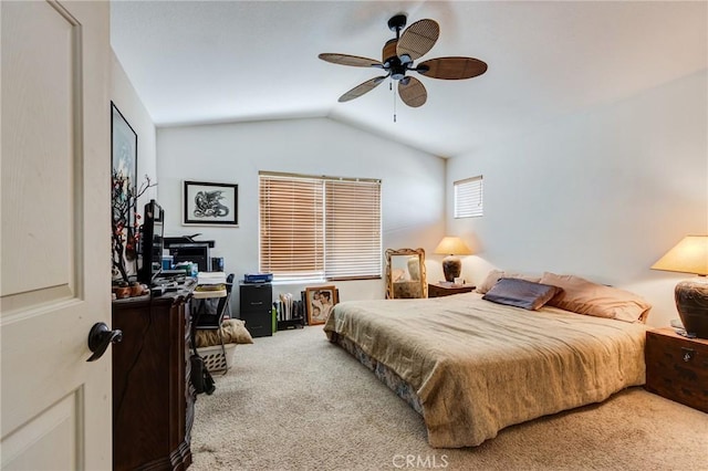 carpeted bedroom featuring lofted ceiling and a ceiling fan