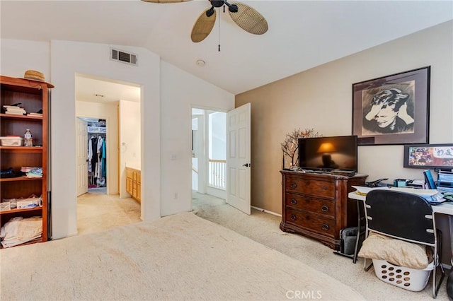 office area featuring vaulted ceiling, ceiling fan, visible vents, and light colored carpet