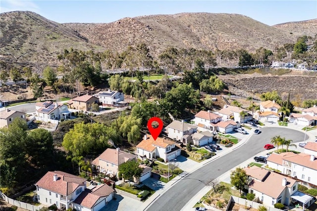 drone / aerial view featuring a residential view and a mountain view