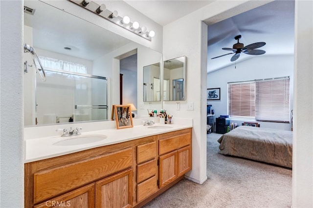 ensuite bathroom featuring double vanity, a sink, a shower with door, and connected bathroom