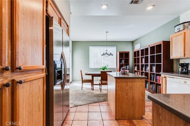 kitchen featuring pendant lighting, dark countertops, a kitchen island, dishwasher, and stainless steel fridge with ice dispenser