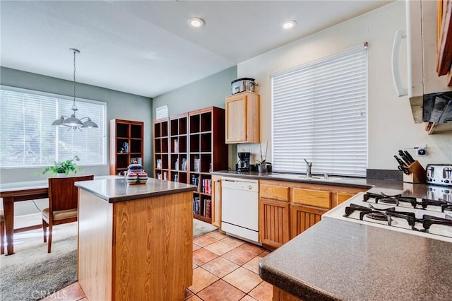 kitchen with dark countertops, decorative light fixtures, and dishwasher