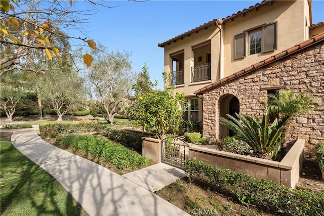 exterior space featuring a gate and a balcony