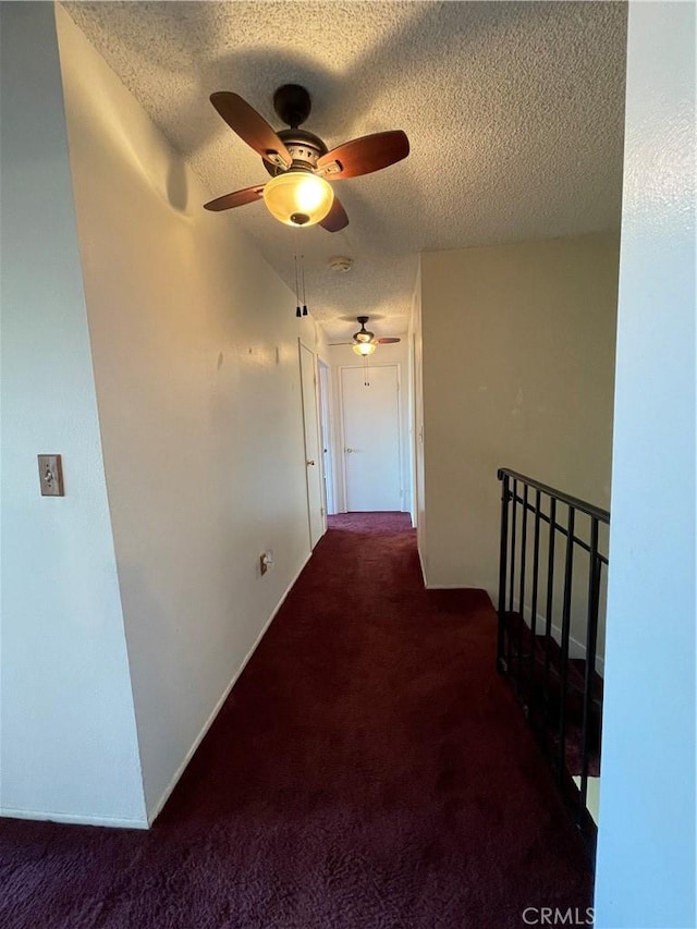 3570 Gettysburg Dr, Riverside, CA 92503 - hall with dark colored carpet, a textured ceiling, and an upstairs landing