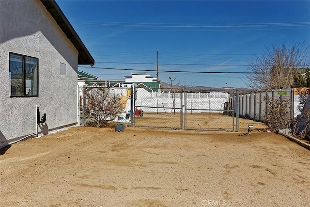 view of yard featuring fence and a gate