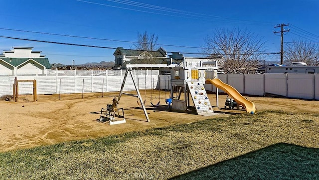 view of playground with a yard and fence