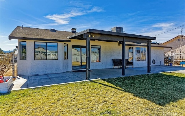 back of property featuring a patio area, fence, stucco siding, and a yard