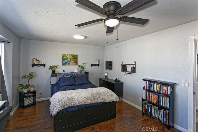 bedroom featuring dark wood-style floors, a textured ceiling, a ceiling fan, and baseboards