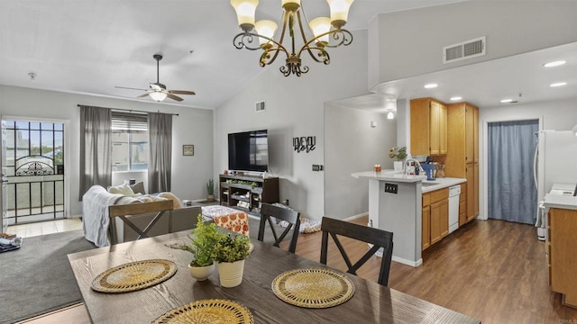 dining room featuring high vaulted ceiling, dark wood-type flooring, visible vents, and a ceiling fan