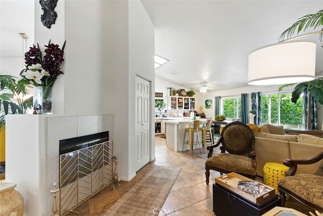 68820 San Felipe Rd, Cathedral City, CA 92234 - living room with vaulted ceiling, light tile patterned floors, ceiling fan, and a fireplace