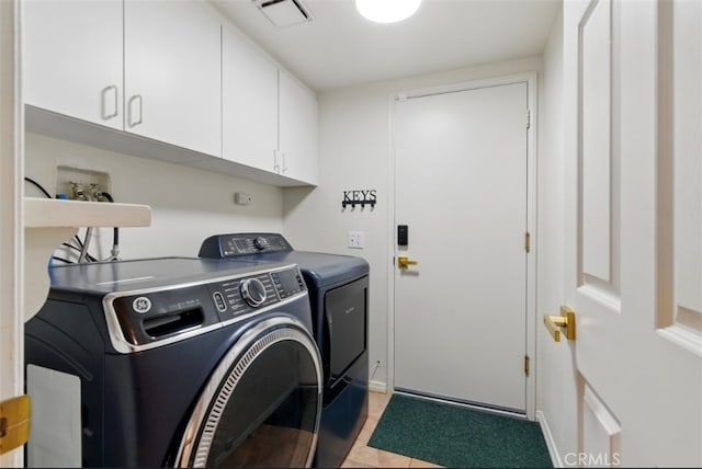 68820 San Felipe Rd, Cathedral City, CA 92234 - washroom with cabinet space, washing machine and dryer, and light tile patterned floors