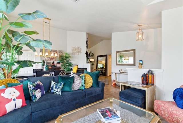 68820 San Felipe Rd, Cathedral City, CA 92234 - living area with tile patterned flooring, a chandelier, vaulted ceiling, and a fireplace