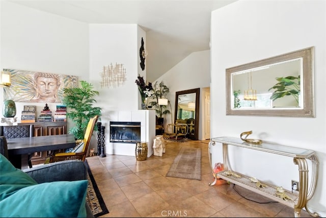 68820 San Felipe Rd, Cathedral City, CA 92234 - living room featuring a tile fireplace, vaulted ceiling, and tile patterned floors