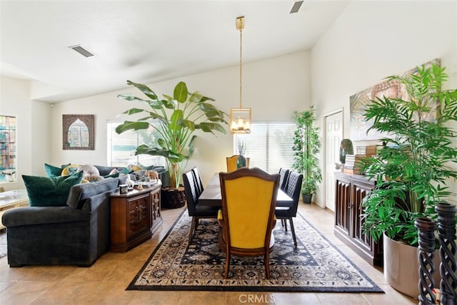 68820 San Felipe Rd, Cathedral City, CA 92234 - dining room with lofted ceiling, light tile patterned flooring, and a chandelier