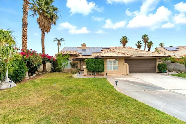 68820 San Felipe Rd, Cathedral City, CA 92234 - view of front of home featuring stucco siding, a garage, a tile roof, concrete driveway, and roof mounted solar panels