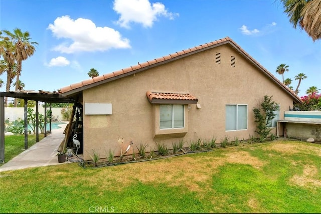68820 San Felipe Rd, Cathedral City, CA 92234 - view of property exterior featuring stucco siding, a tile roof, and a lawn