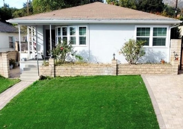 view of front of property with a front lawn and stucco siding