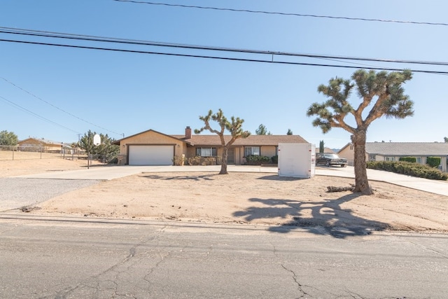 view of front of house with a garage, driveway, and stucco siding