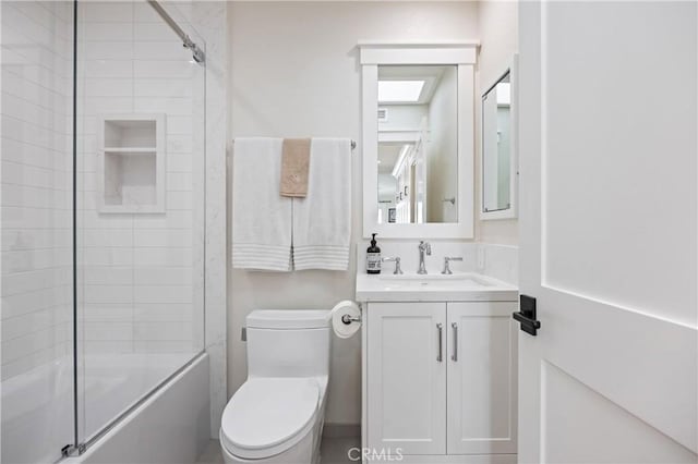 full bathroom with toilet, enclosed tub / shower combo, and vanity