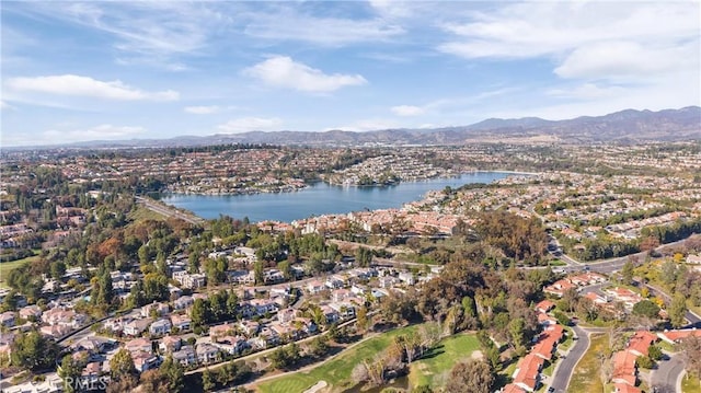 drone / aerial view with a residential view and a water and mountain view