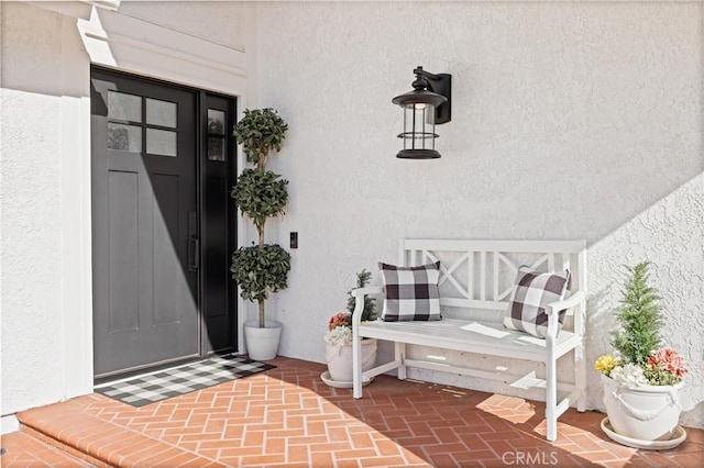 view of exterior entry with stucco siding