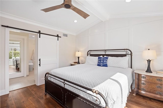 bedroom featuring a barn door, visible vents, lofted ceiling with beams, dark wood-style floors, and a decorative wall