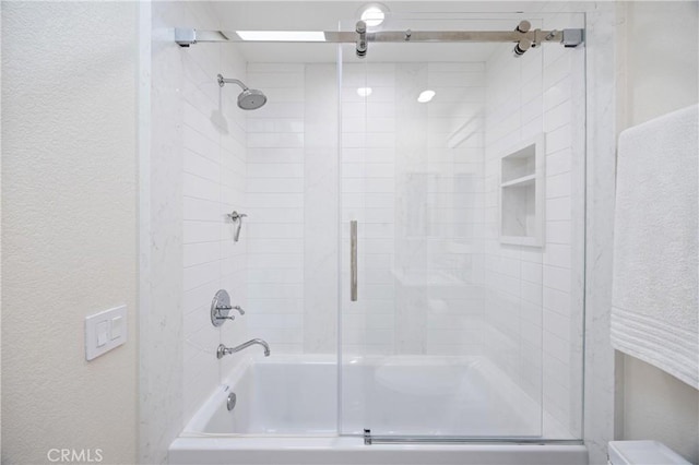 full bathroom featuring bath / shower combo with glass door