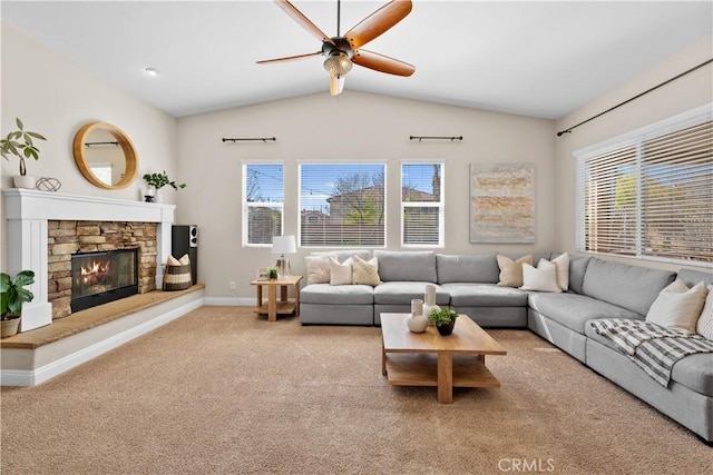 living area with lofted ceiling, a fireplace, baseboards, and a healthy amount of sunlight