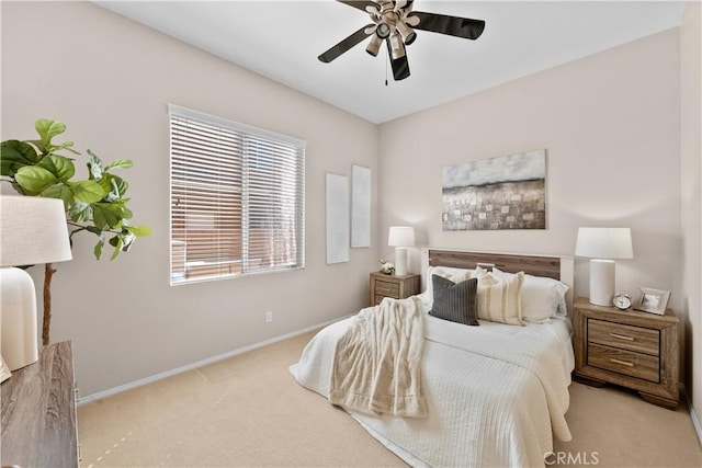 bedroom with a ceiling fan, carpet flooring, and baseboards