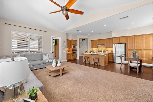 living room featuring dark colored carpet, recessed lighting, visible vents, a ceiling fan, and vaulted ceiling