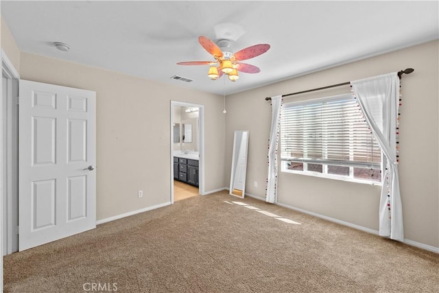 unfurnished bedroom with visible vents, light carpet, baseboards, and ensuite bathroom