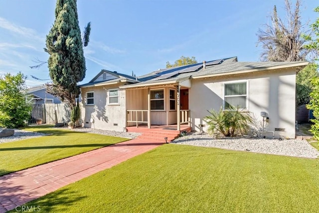 single story home featuring a sunroom, crawl space, roof mounted solar panels, a front lawn, and stucco siding