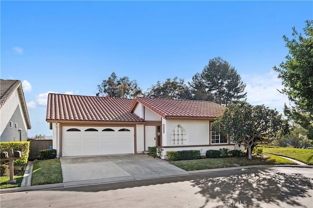 mediterranean / spanish-style house featuring a garage, fence, a tiled roof, driveway, and stucco siding