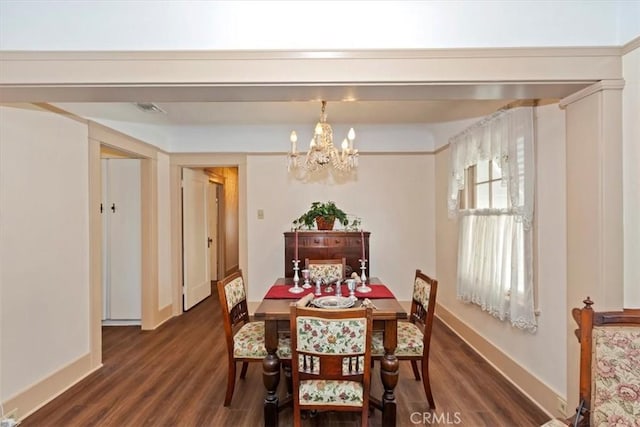 dining room with dark wood-style flooring, baseboards, and an inviting chandelier