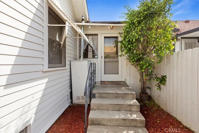 doorway to property with fence