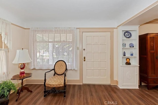 living area with dark wood finished floors and baseboards