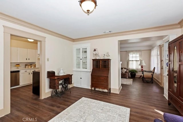 interior space featuring dark wood-style floors, visible vents, and crown molding