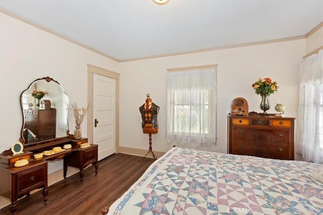 bedroom with baseboards, ornamental molding, and dark wood finished floors