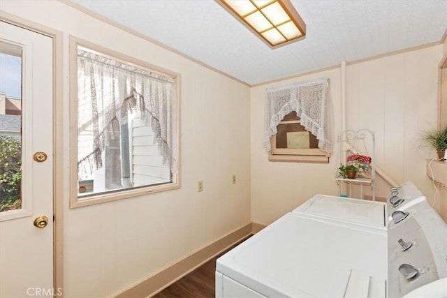 laundry area featuring ornamental molding, laundry area, separate washer and dryer, and dark wood-type flooring