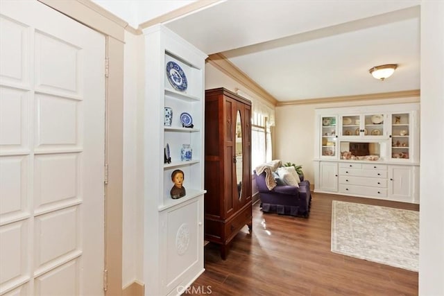 interior space featuring wood finished floors and crown molding