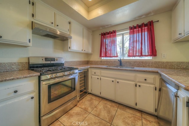 8371 Hawthorne St, Rancho Cucamonga, CA 91701 - kitchen featuring stainless steel gas range oven, under cabinet range hood, beverage cooler, light tile patterned floors, and light countertops