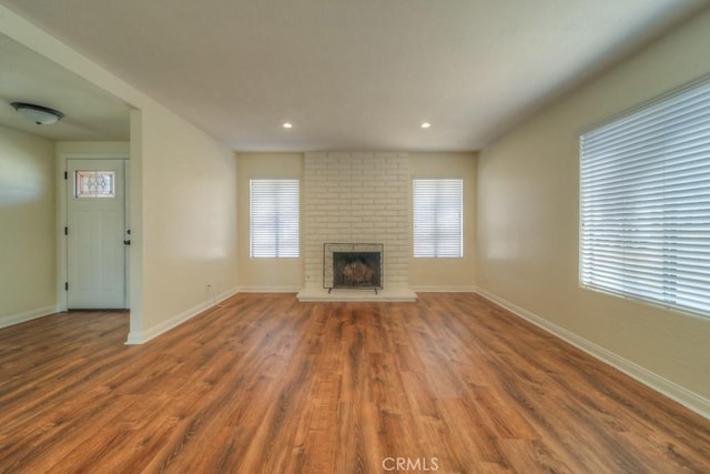 8371 Hawthorne St, Rancho Cucamonga, CA 91701 - unfurnished living room with a fireplace, plenty of natural light, wood finished floors, and recessed lighting
