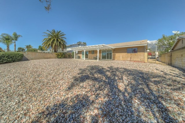 8371 Hawthorne St, Rancho Cucamonga, CA 91701 - back of house featuring a fenced backyard, a pergola, and stucco siding