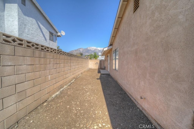 8371 Hawthorne St, Rancho Cucamonga, CA 91701 - view of home's exterior with a fenced backyard, stucco siding, and a mountain view