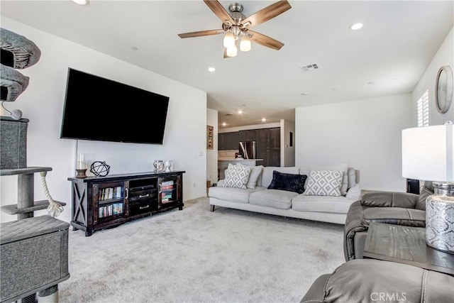 living room with carpet floors, ceiling fan, visible vents, and recessed lighting