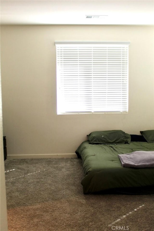 bedroom featuring visible vents and dark carpet