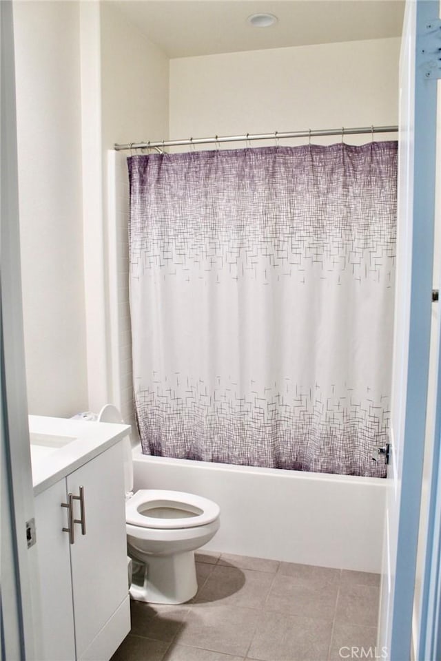 bathroom with toilet, tile patterned flooring, shower / tub combo with curtain, and vanity